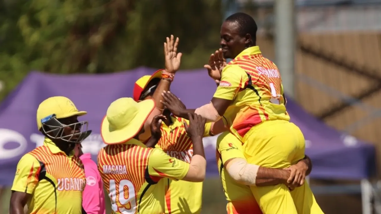 Ugandan cricket players celebrating victory on field.