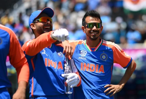 Indian cricketers laughing during a sunny match day.