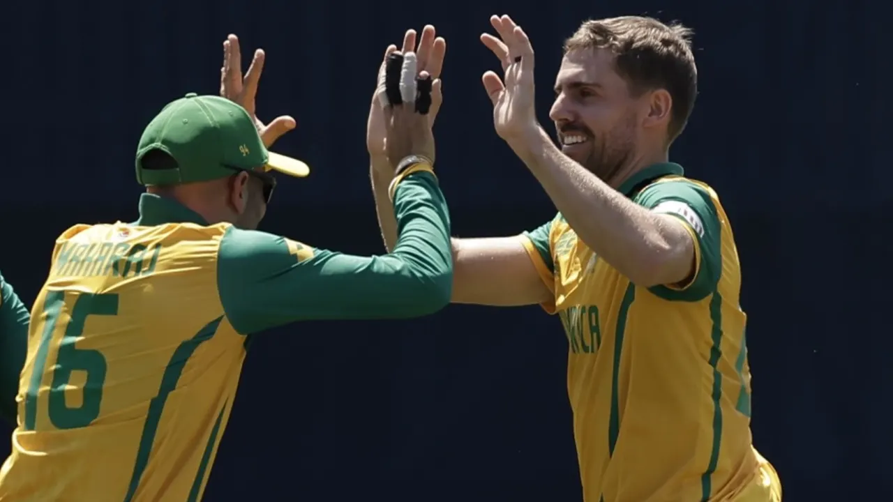 Cricket players celebrating with a high five.