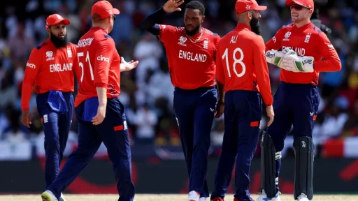 England cricket team celebrating during a sunny match.