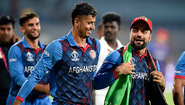 Afghanistan cricket players celebrating on the field.