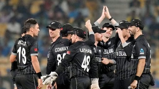 New Zealand cricket team celebrating during a night match.