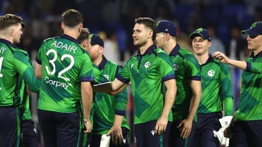 Irish cricket team celebrating during a night match.