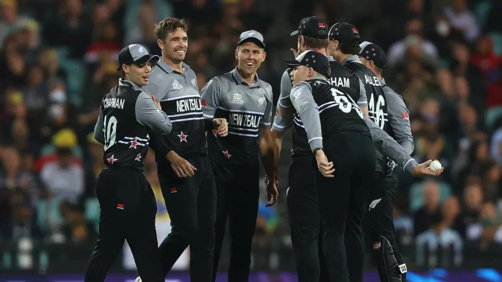 New Zealand cricket team celebrating during a night match.
