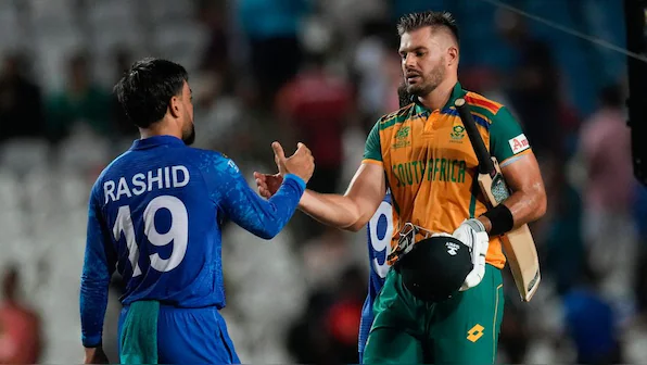 Cricketers from Afghanistan and South Africa shaking hands