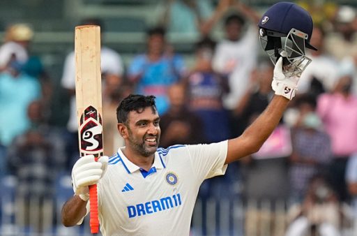 Cricket player celebrating with bat raised at stadium