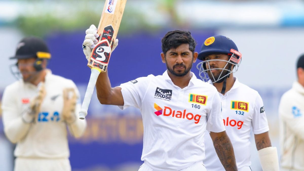 Cricketer celebrating a century with raised bat