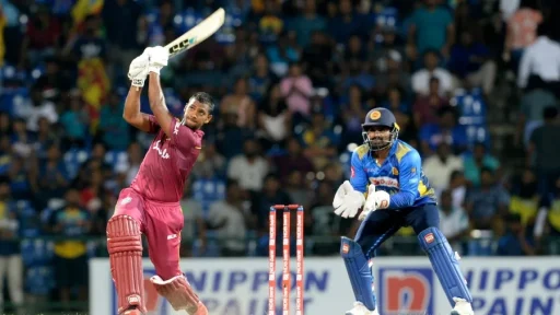 Cricketer hitting ball during match against wicketkeeper