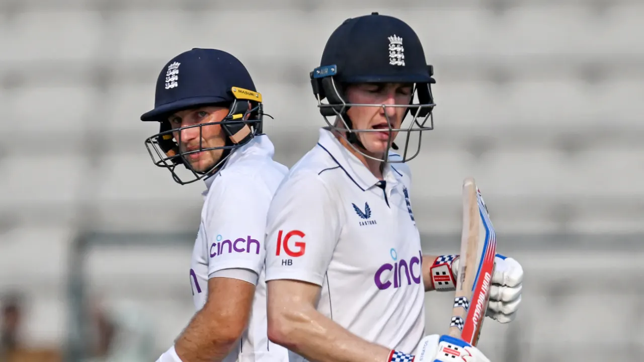 Two male cricket players in England gear walking