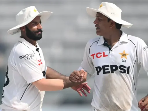 Two cricketers shaking hands on the field