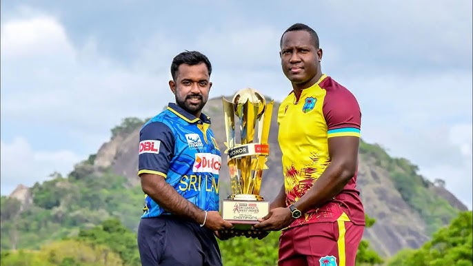 Two cricketers holding trophy outdoors with scenic backdrop