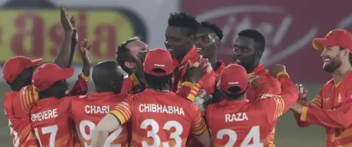 Cricket team celebrating victory on field at night