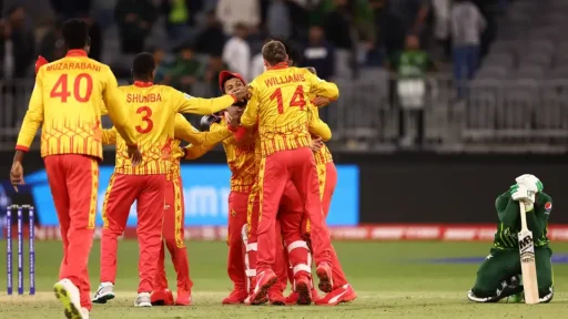 Cricket team celebrates victory while opponent kneels disappointed