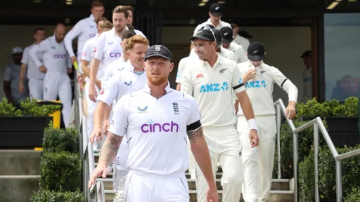 Cricketers from England and New Zealand walking down stairs