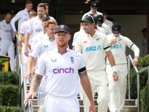 Cricketers from England and New Zealand walking down stairs