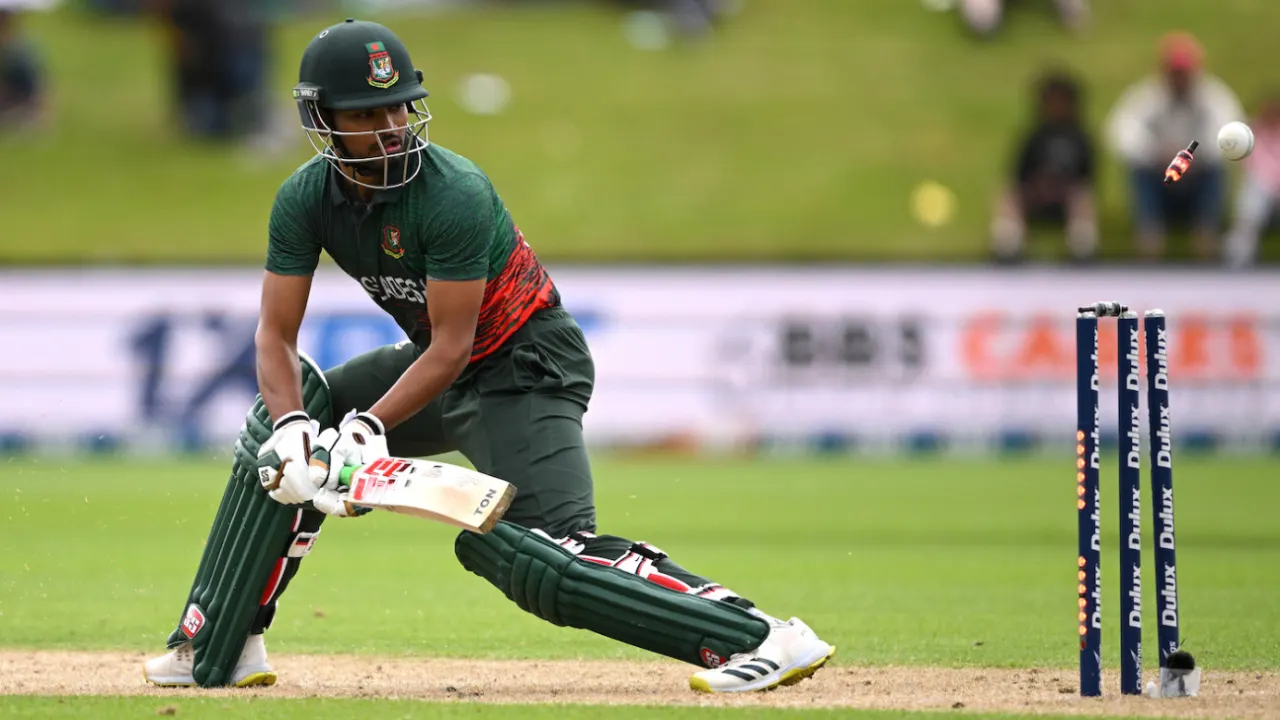 Cricketer executing a defensive shot during a match