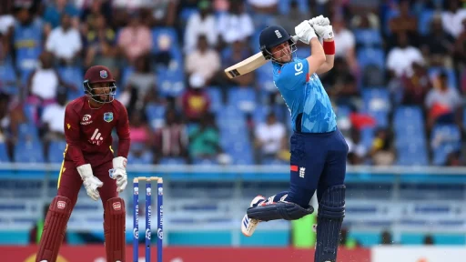 Cricketer hitting ball during match, wicketkeeper behind