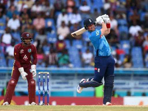 Cricketer hitting ball during match, wicketkeeper behind