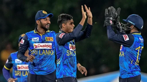 Sri Lankan cricketers celebrating a wicket at night