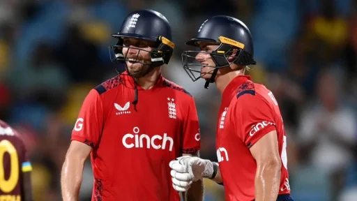 Two English cricketers chatting during a night match