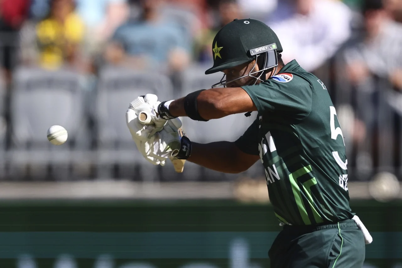 Cricketer hitting ball during outdoor match