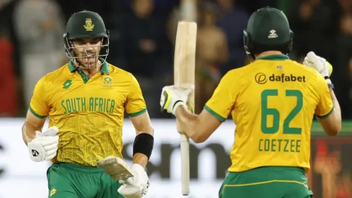 South African cricketers celebrating during a night match