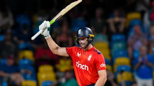 Cricketer celebrating a shot in red uniform