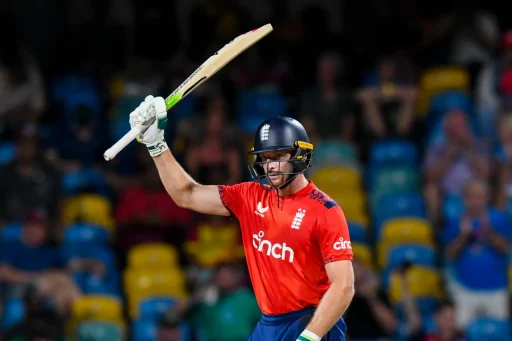 Cricketer celebrating a shot in red uniform