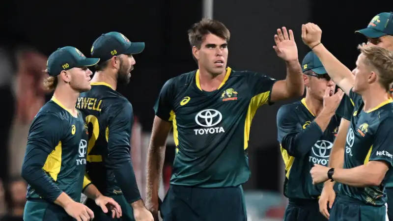 Australian cricketers celebrating during a night match