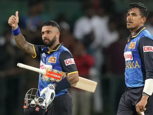 Cricket players celebrating during a night match