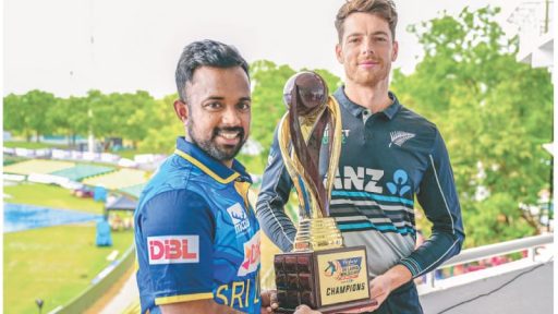 Two cricketers holding championship trophy together