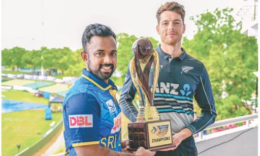 Two cricketers holding championship trophy together