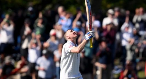 Cricketer celebrating victory with raised bat