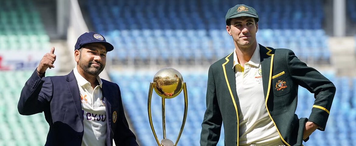 Two cricket players with trophy on sunny stadium field