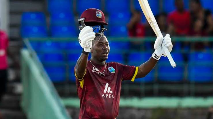 Cricketer celebrating victory with raised bat