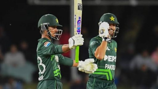 Pakistani cricketers celebrating during a night match