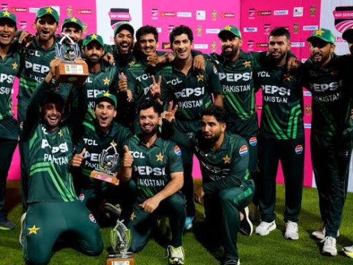 Pakistani cricket team celebrating with trophy at night