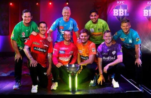 Cricket players from different teams posing with trophy