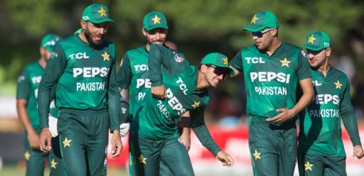 Pakistani cricketers walking and smiling on field