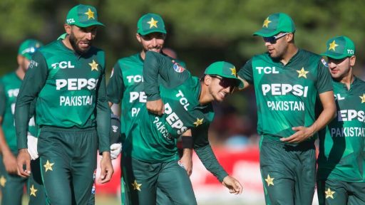 Pakistani cricketers walking and smiling on field