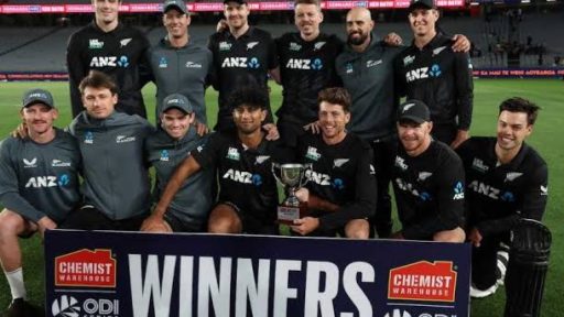 Cricket team celebrating with trophy at stadium.