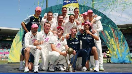 Cricket team celebrating victory with trophy on field