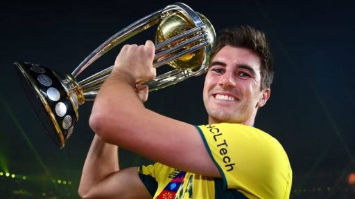 Smiling athlete lifting championship trophy at night