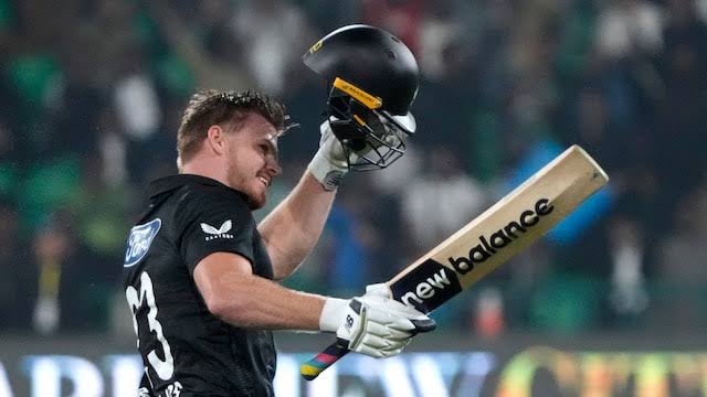 Cricketer celebrating with helmet and bat in stadium