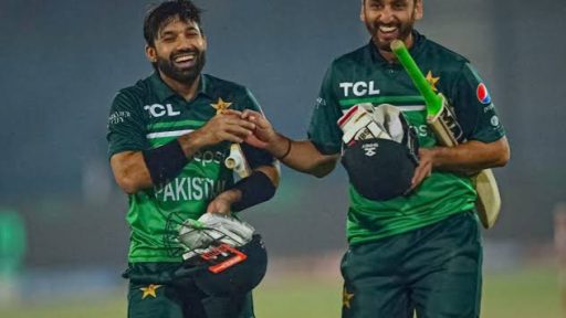 Two Pakistani cricketers celebrating a victory on field