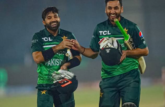 Two Pakistani cricketers celebrating a victory on field