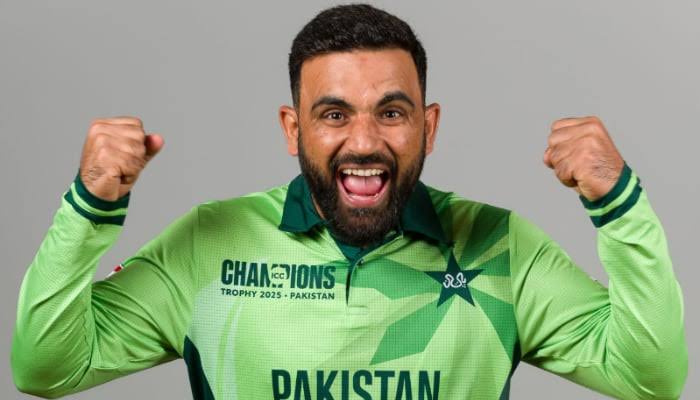 Excited cricketer in Pakistan team jersey celebrating